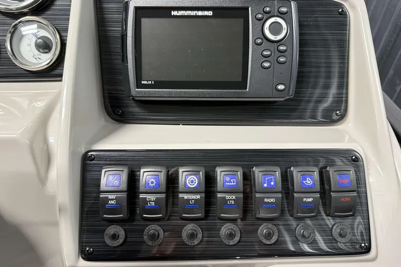 Slide: The Image of Control panel of 2026 Sylvan Mirage 8520 Cruise with switches and Humminbird Helix 5 display. - 9