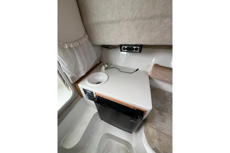 Slide: The Image of Interior of 2004 Seaswirl Striper 2601 Walkaround I/O with sink and mini fridge. - 2