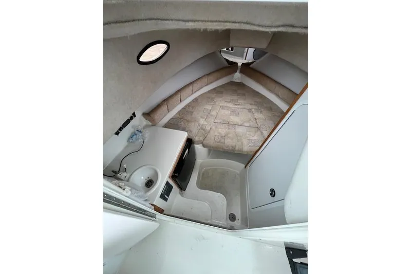 Slide: The Image of 2004 Seaswirl Striper 2601 Walkaround I/O cabin interior with compact kitchenette and seating area. - 3