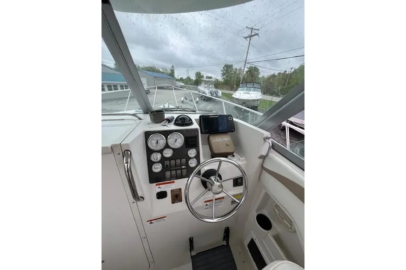 Slide: The Image of 2004 Seaswirl Striper 2601 Walkaround I/O boat cockpit with steering wheel and gauges. - 4