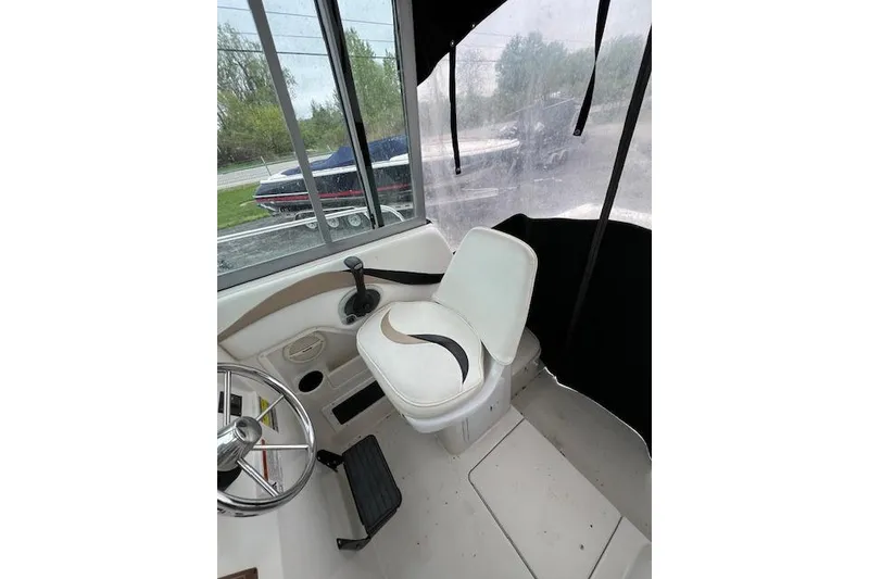 Slide: The Image of 2004 Seaswirl Striper 2601 Walkaround I/O boat interior with steering wheel and seat. - 6