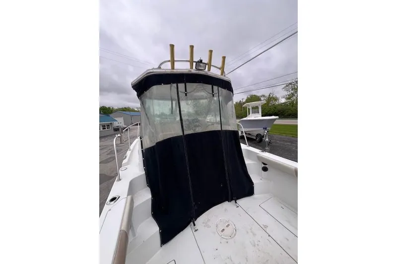 Slide: The Image of 2004 Seaswirl Striper 2601 Walkaround I/O boat with covered cockpit and rod holders. - 8