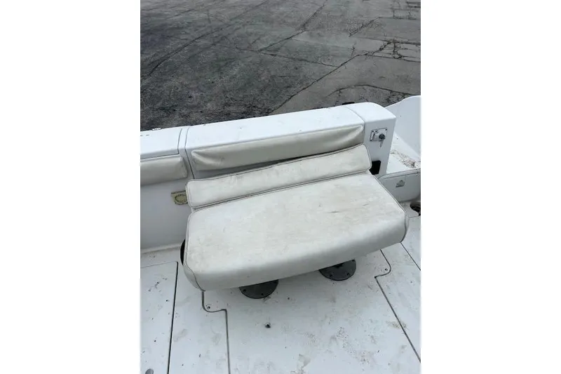 Slide: The Image of 2004 Seaswirl Striper 2601 Walkaround I/O boat seat, white upholstery, outdoor setting. - 9