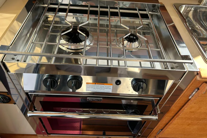Slide: The Image of Stainless steel stove and oven in 2020 Ranger Tugs R-27 boat kitchen. - 14