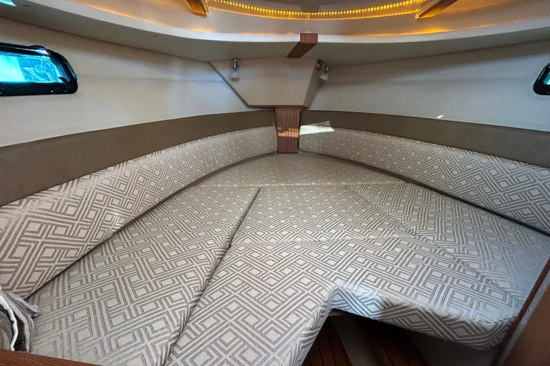 Slide: The Image of Interior cabin of 2020 Ranger Tugs R-27 with patterned cushions and ambient lighting. - 15