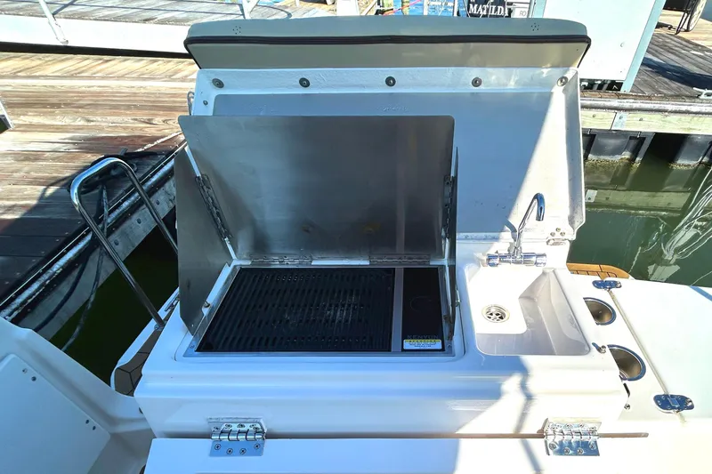 Slide: The Image of Outdoor kitchen on 2020 Ranger Tugs R-27 boat with grill and sink. - 21