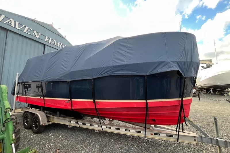 Slide: The Image of 2020 Ranger Tugs R-27 boat covered on trailer at marina. - 3