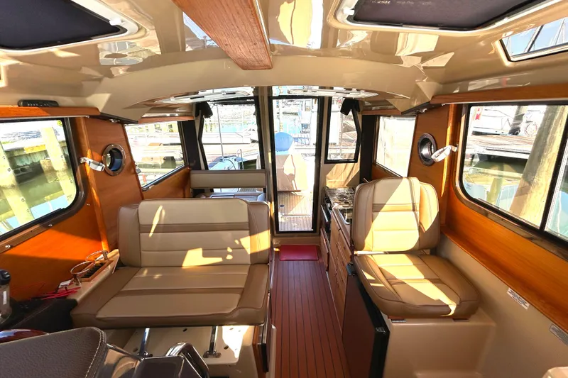 Slide: The Image of Interior of 2020 Ranger Tugs R-27 boat with seating and wood accents. - 5