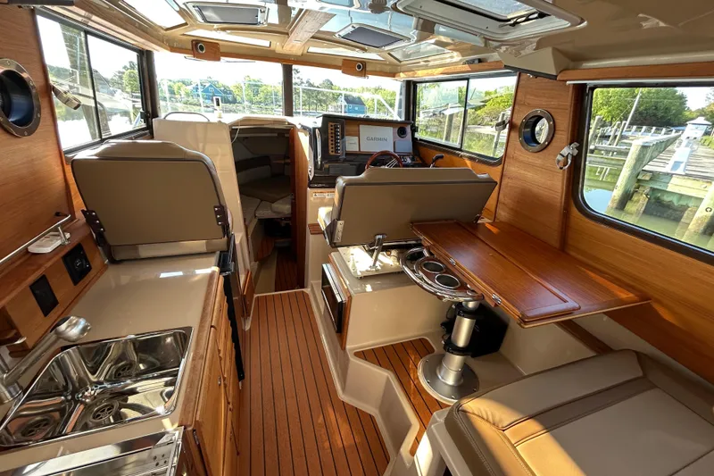 Slide: The Image of Interior of 2020 Ranger Tugs R-27 boat with wood finish and modern amenities. - 7