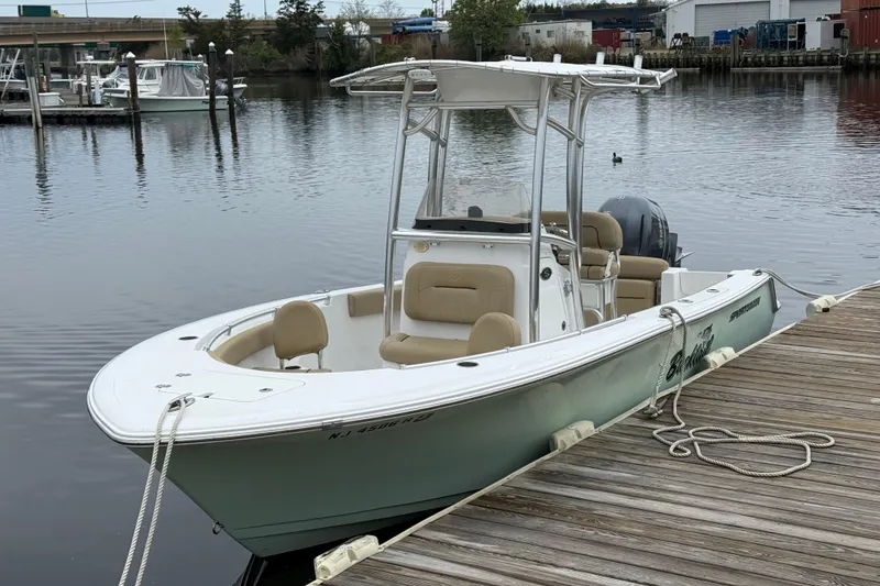 The Image of 2018 Sportsman Open 212 Center Console boat docked by a wooden pier. - 0