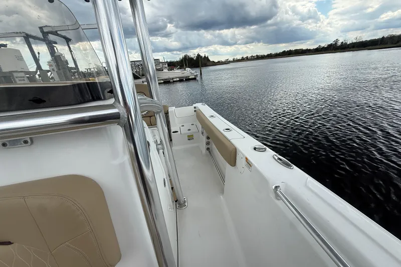 Slide: The Image of 2018 Sportsman Open 212 Center Console boat on calm water under cloudy sky. - 10