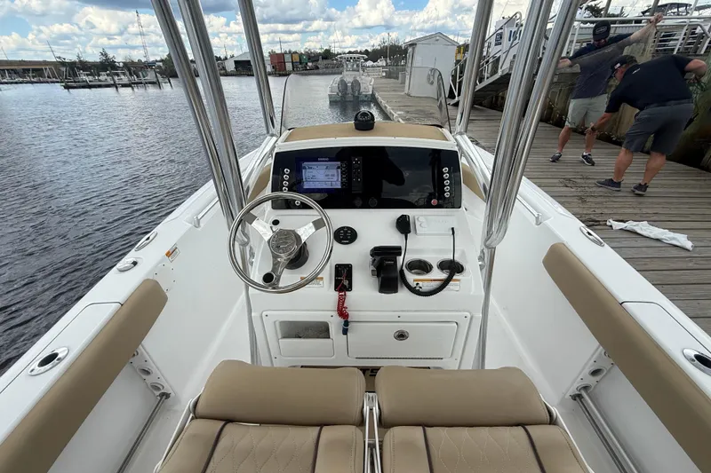 Slide: The Image of 2018 Sportsman Open 212 Center Console boat at dock, featuring helm and seating. - 12