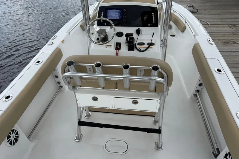Slide: The Image of 2018 Sportsman Open 212 Center Console boat interior with steering wheel and rod holders. - 14