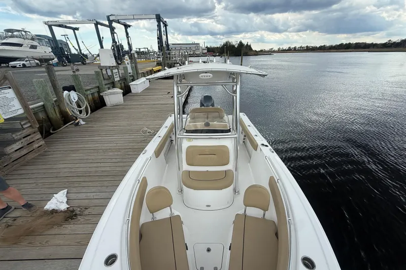 Slide: The Image of 2018 Sportsman Open 212 Center Console boat docked by a wooden pier. - 3