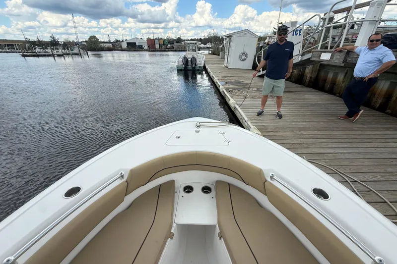 Slide: The Image of 2018 Sportsman Open 212 Center Console docked, with two people on the pier. - 4