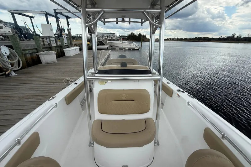 Slide: The Image of 2018 Sportsman Open 212 Center Console boat docked by a serene waterfront. - 7
