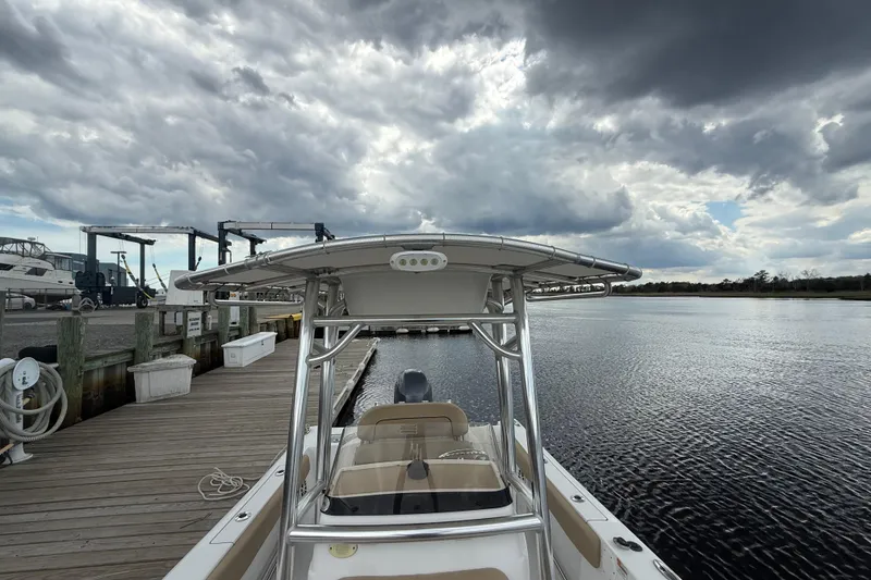 Slide: The Image of 2018 Sportsman Open 212 Center Console boat docked under cloudy skies. - 8