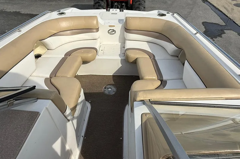 Slide: The Image of 2014 Starcraft Crossover 210 SCX OB boat interior with beige seating and carpeted floor. - 10