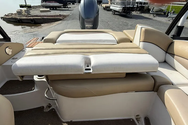 Slide: The Image of 2014 Starcraft Crossover 210 SCX OB boat interior with beige seating and outboard motor. - 11