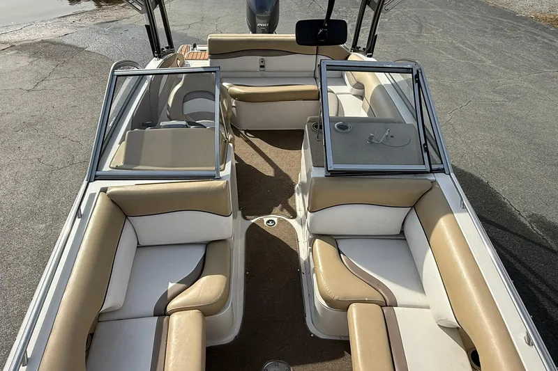 Slide: The Image of 2014 Starcraft Crossover 210 SCX OB boat interior with beige and white seating. - 16