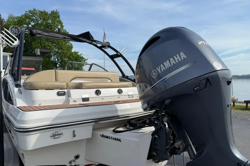 Slide: The Image of 2014 Starcraft Crossover 210 SCX OB boat with Yamaha outboard motor by a lake. - 3