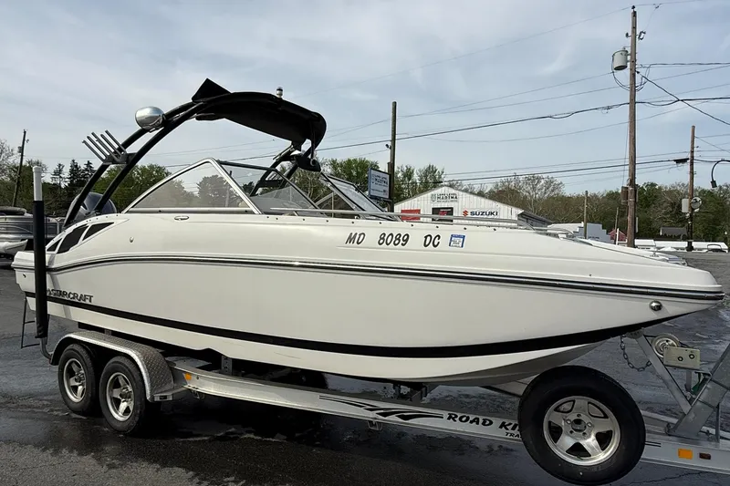 Slide: The Image of 2014 Starcraft Crossover 210 SCX OB boat on trailer, parked outdoors. - 5