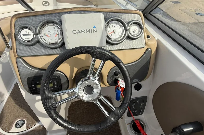 Slide: The Image of 2014 Starcraft Crossover 210 SCX OB dashboard with Garmin GPS and steering wheel. - 9