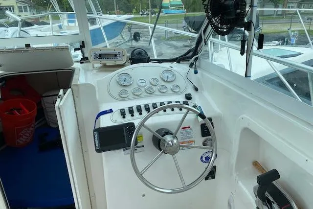 Slide: The Image of 2007 Baha Cruisers 251 GLE boat cockpit with steering wheel and control panel. - 3