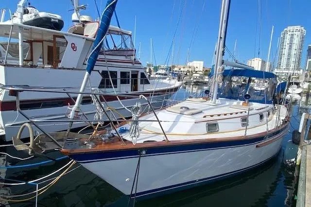 The Image of 1982 Endeavour 40 sailboat docked in a marina, surrounded by other boats. - 0