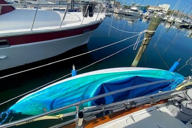 Slide: The Image of Blue kayak on Endeavour 40 sailboat, docked in marina, 1982 model. - 14
