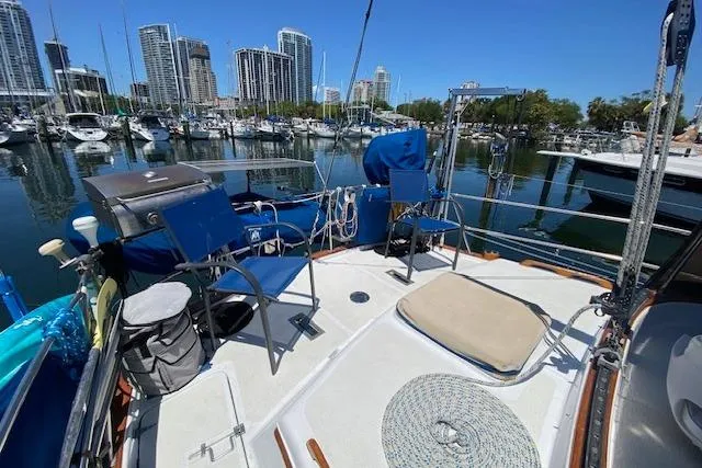 Slide: The Image of Sailboat deck with chairs, city skyline, and marina view; Endeavour 40, 1982 model. - 15
