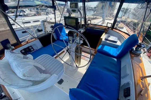 Slide: The Image of Cockpit of 1982 Endeavour 40 sailboat with blue cushions and steering wheel. - 19