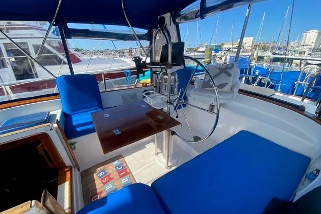 Slide: The Image of Cockpit of 1982 Endeavour 40 sailboat with blue seating and wooden table. - 20