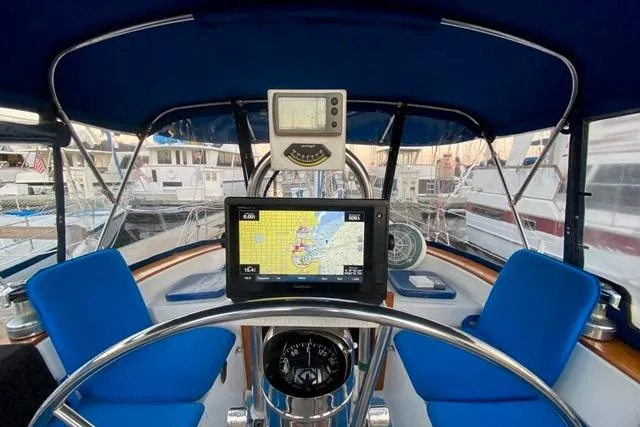 Slide: The Image of Cockpit of 1982 Endeavour 40 sailboat with navigation equipment and blue seating. - 24