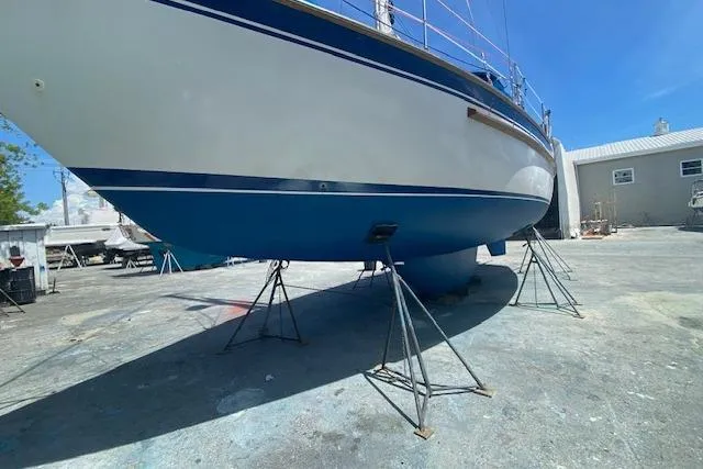 Slide: The Image of 1982 Endeavour 40 sailboat on stands in a boatyard under clear blue sky. - 27