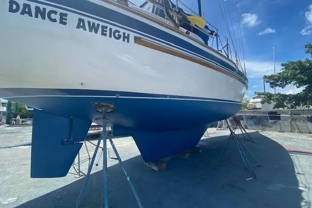 Slide: The Image of 1982 Endeavour 40 sailboat "Dance Aweigh" on stands, blue hull, sunny day. - 28