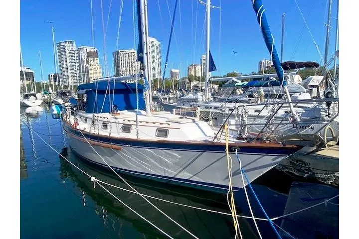 Slide: The Image of 1982 Endeavour 40 sailboat docked in marina with city skyline background. - 3
