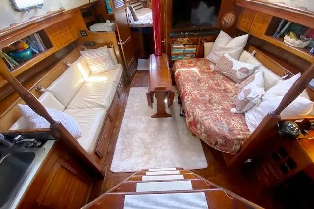 Slide: The Image of Cozy interior of 1982 Endeavour 40 sailboat with seating and bedding areas. - 33