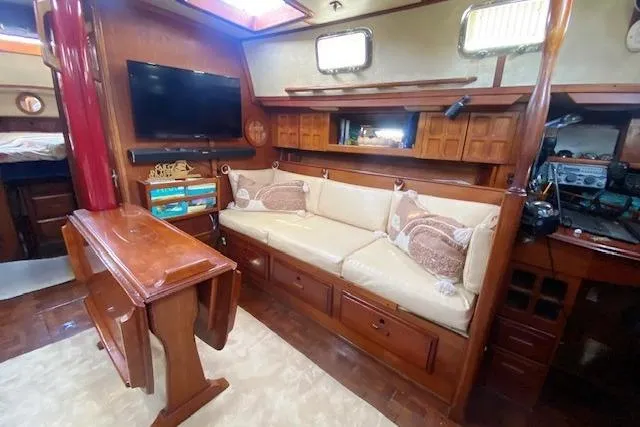 Slide: The Image of Interior of 1982 Endeavour 40 yacht with cozy seating and wooden furnishings. - 35