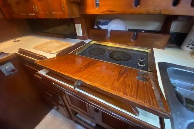 Slide: The Image of Wooden galley kitchen in 1982 Endeavour 40 sailboat with stove and sink. - 42