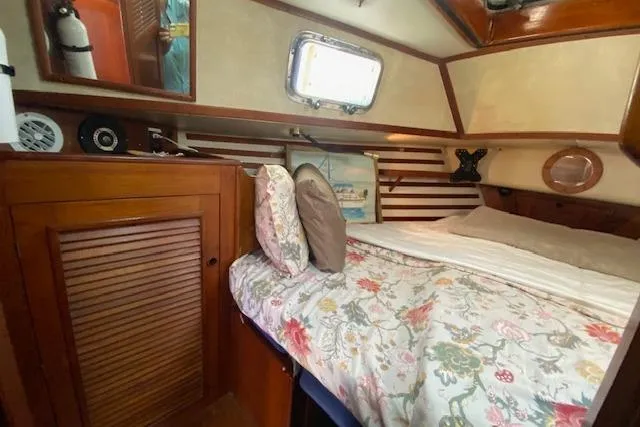 Slide: The Image of Cozy cabin interior of 1982 Endeavour 40 sailboat with floral bedding and wooden accents. - 44