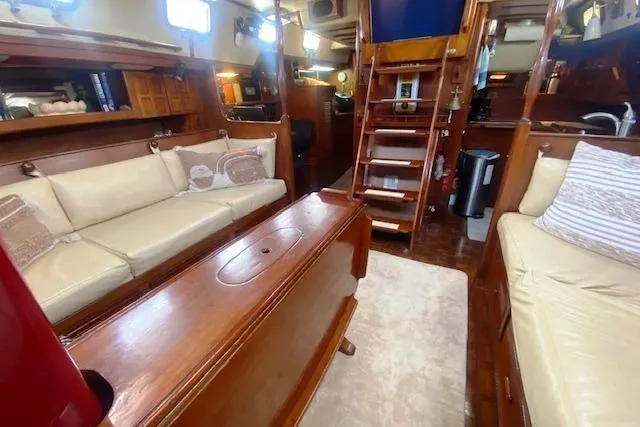Slide: The Image of Interior of 1982 Endeavour 40 sailboat with cozy seating and wooden finishes. - 47