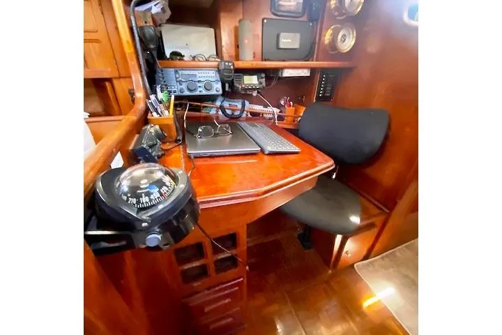 Slide: The Image of Navigation station inside 1982 Endeavour 40 sailboat with radio equipment and compass. - 48