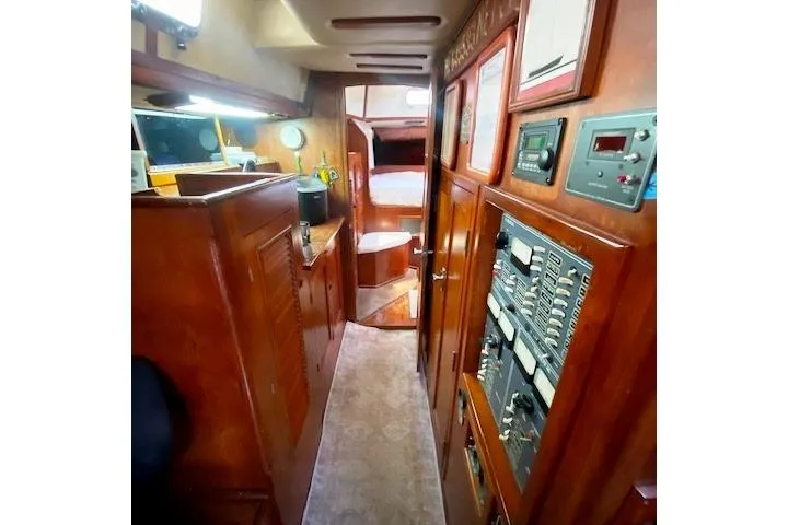 Slide: The Image of Interior of 1982 Endeavour 40 sailboat with wood paneling and control panels. - 49