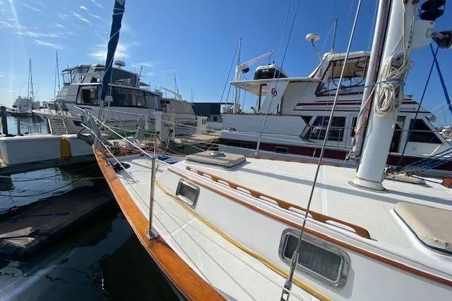 Slide: The Image of 1982 Endeavour 40 sailboat docked at marina under clear blue sky. - 5