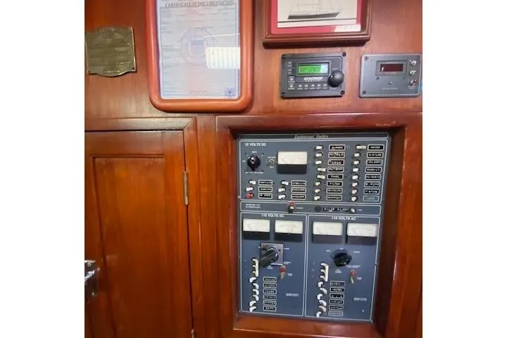 Slide: The Image of Electrical control panel on a 1982 Endeavour 40 sailboat, featuring various switches and gauges. - 50