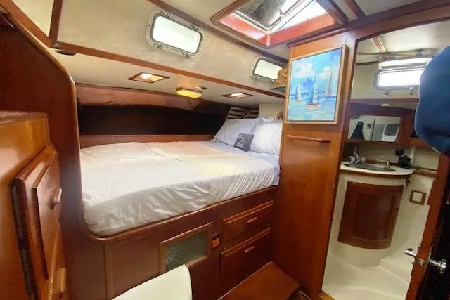 Slide: The Image of Cozy cabin interior of 1982 Endeavour 40 sailboat with bed and compact bathroom. - 52