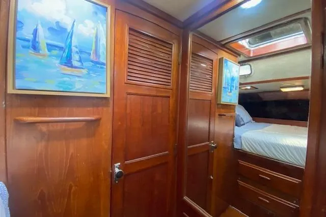 Slide: The Image of Cozy 1982 Endeavour 40 yacht cabin with wooden interior and sailboat paintings. - 54