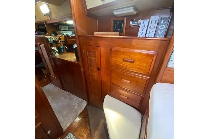 Slide: The Image of Interior of 1982 Endeavour 40 sailboat with wooden cabinetry and cozy decor. - 56