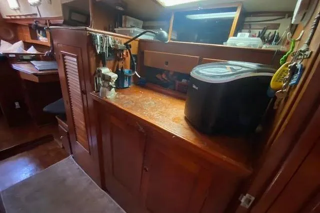 Slide: The Image of 1982 Endeavour 40 yacht interior with wooden cabinetry and modern appliances. - 57